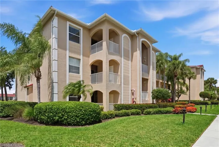 The property features a stucco exterior with multiple balconies and arched architectural details