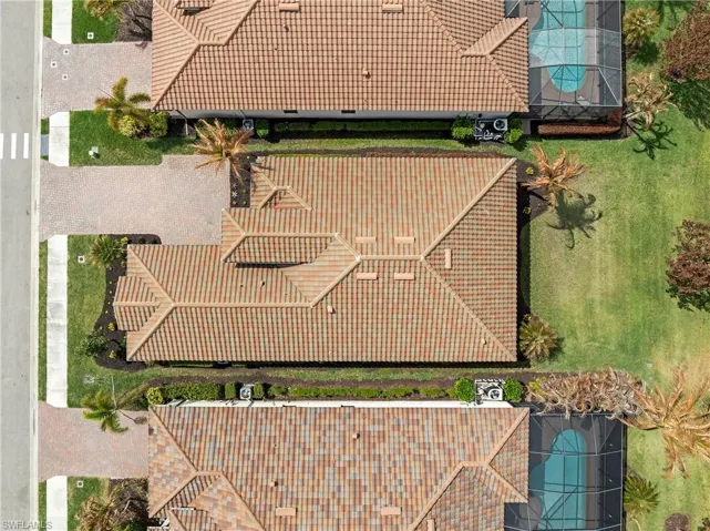 Aerial view of property and surrounding area featuring a pool