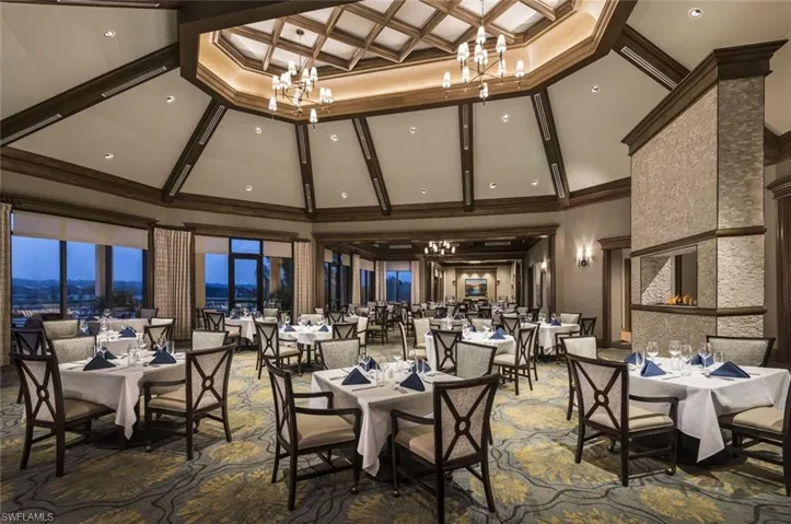 Dining room with hanging lights, coffered ceiling, and ornamental molding