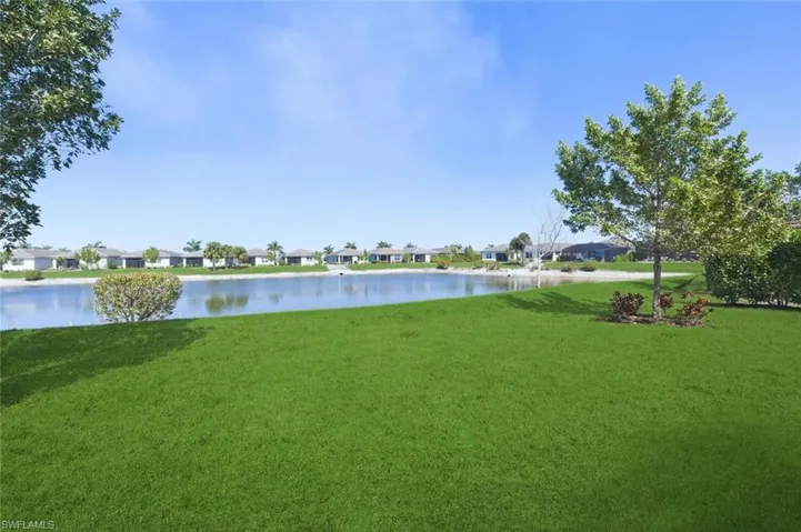 View of green lawn with a water view and a residential view