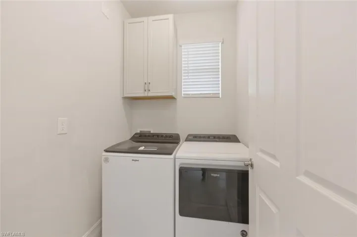 Laundry room featuring cabinet space and washing machine and clothes dryer
