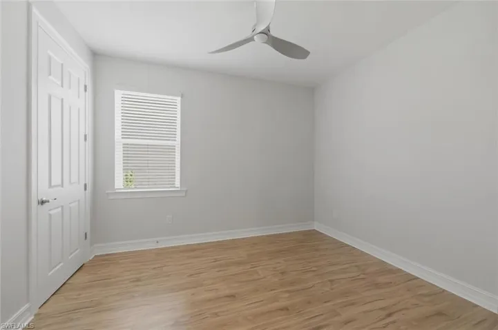 Unfurnished bedroom featuring light wood finished floors and a ceiling fan