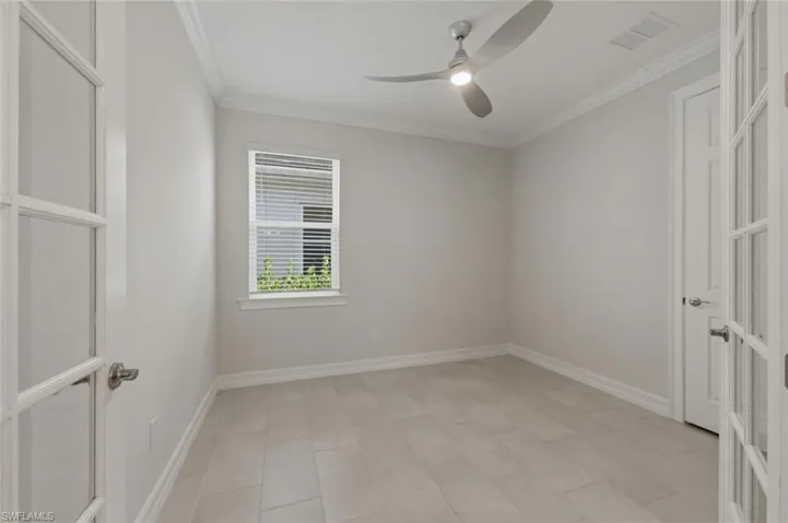 Unfurnished room with ornamental molding and ceiling fan