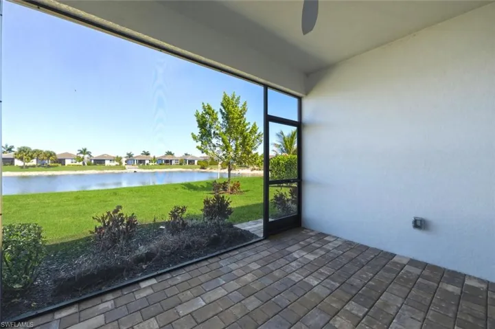 Unfurnished sunroom featuring a water view and a residential view