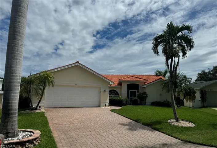 View of front of property featuring a garage and a front yard