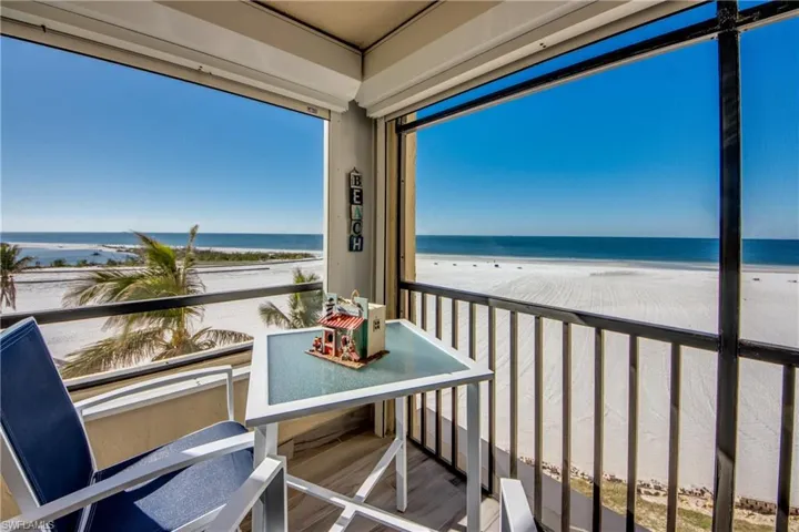 Screened in lanai with views of the beach