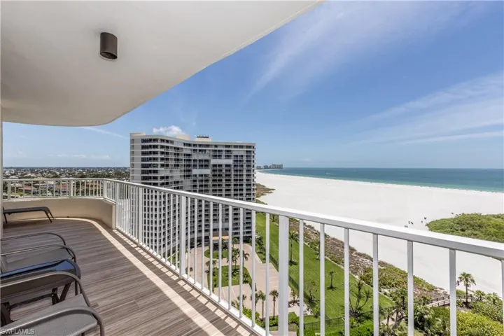 Balcony featuring a beach view and a water view