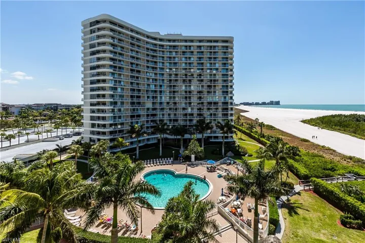 Pool with a water view and a view of the beach