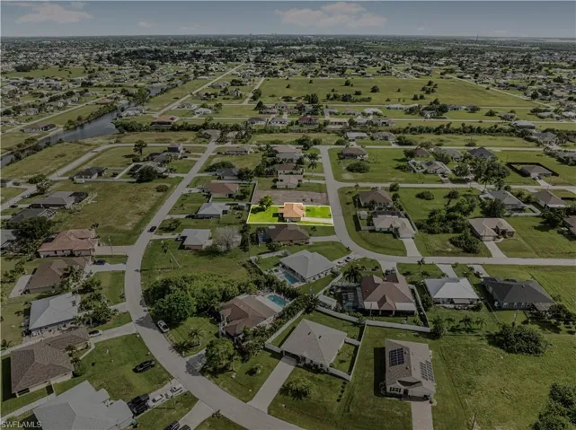 Drone / aerial view with a residential view and a water view