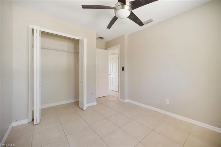 Bedroom #2 with visible vents, a closet, and light tile patterned flooring