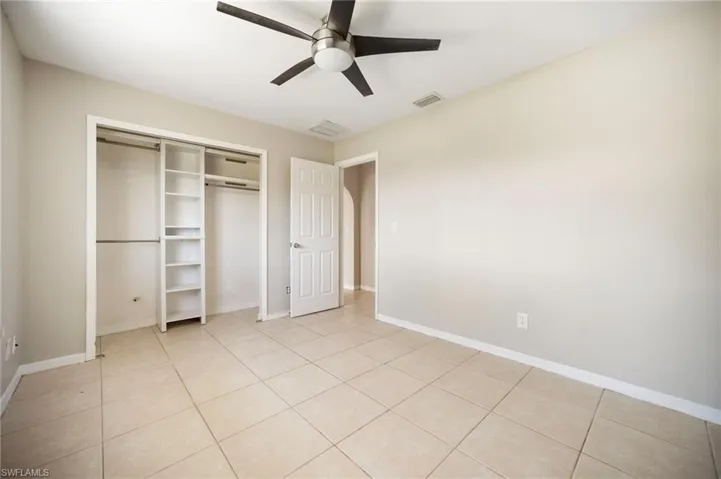 Unfurnished bedroom #1 featuring a closet, visible vents, baseboards, and light tile patterned floors