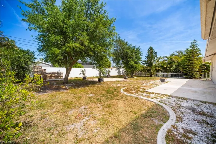 View of yard featuring a fenced backyard and a patio