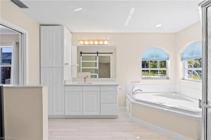 Primary bathroom with ample cabinet storage for a clutter-free, organized space.