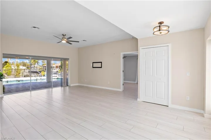 Light-filled living space with neutral flooring throughout, flowing effortlessly from kitchen to outdoor entertaining areas.