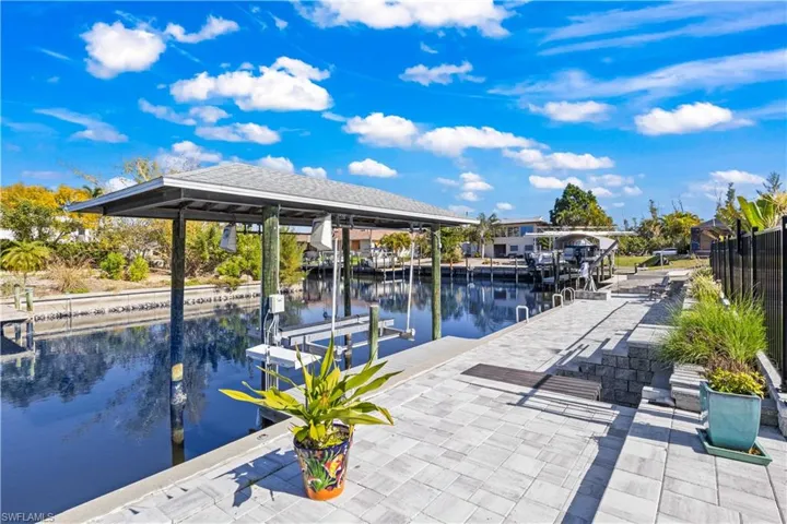 A private, deep-water dock with covered lift and kayak launch, where manatees and dolphins become part of your daily backdrop.