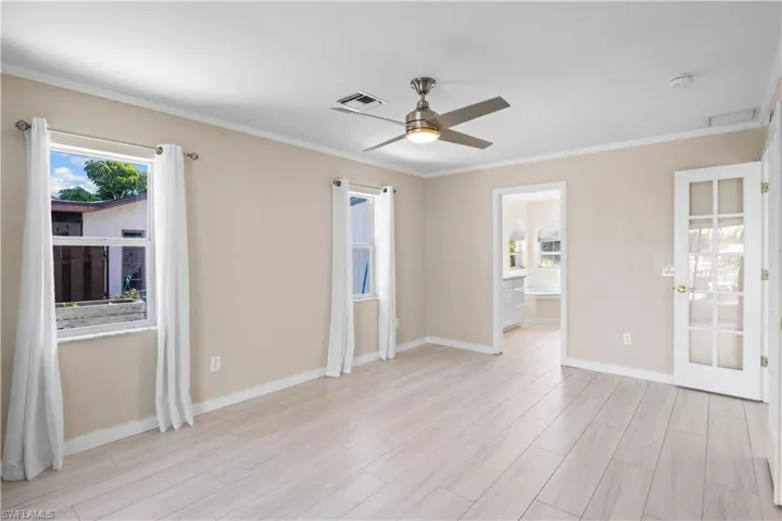 A serene master suite combining comfort, style, and direct access to the pool and canal.