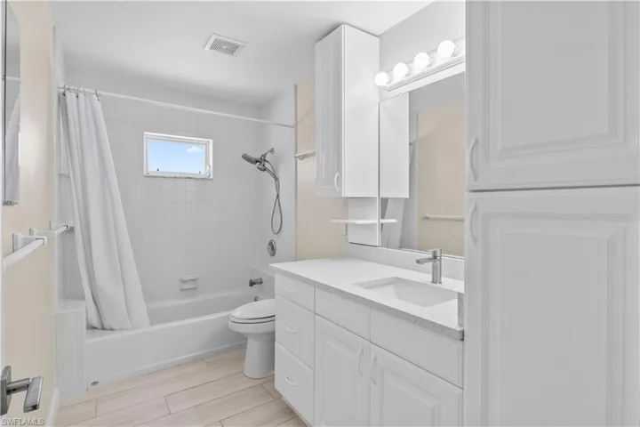Guest bathroom with a combination tub/shower and ample natural light.