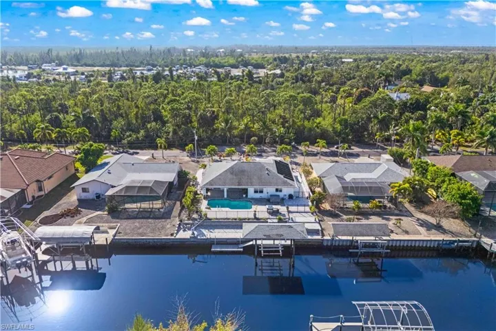 Direct Gulf access with no bridges—your private dock with covered boat lift and kayak launch on scenic Manatee Canal, where dolphins and manatees frequently visit.
