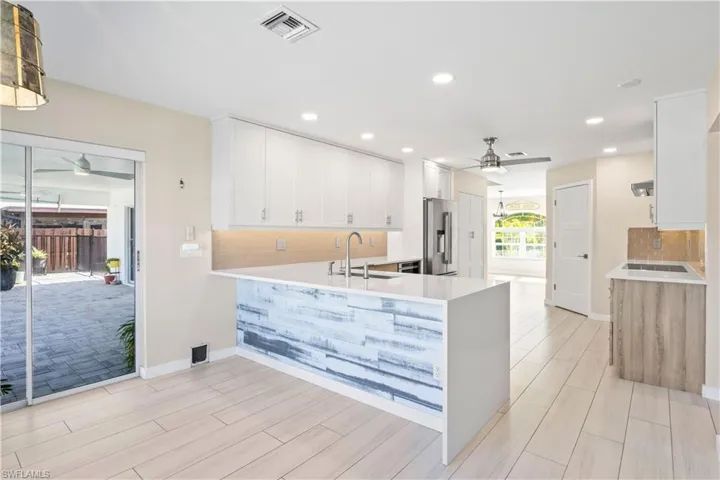 Kitchen designed for effortless entertaining, with ample counter space and sleek, coastal-inspired details.