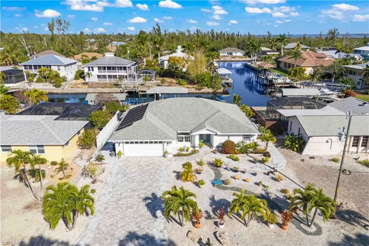 A picture-perfect streetscape framed by lush palms and refined coastal lines.