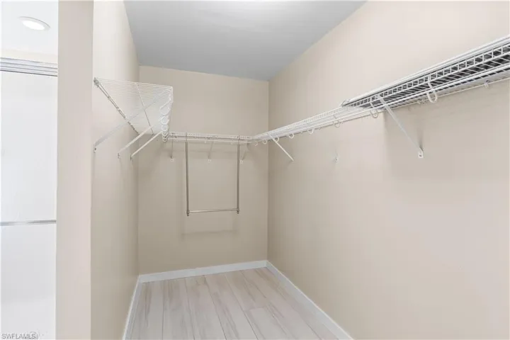 Spacious master closet designed for organization, with plenty of hanging space.