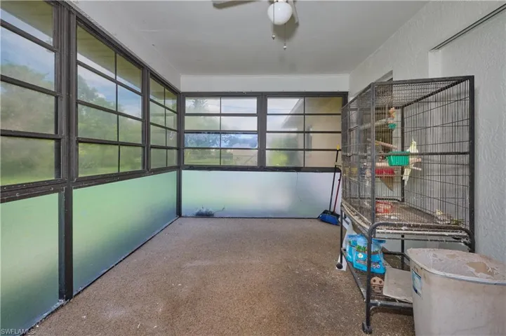 Unfurnished sunroom with ceiling fan