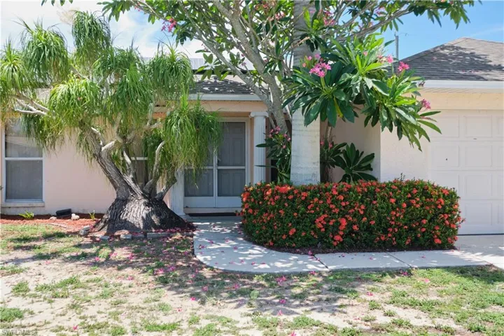 View of exterior entry with a garage