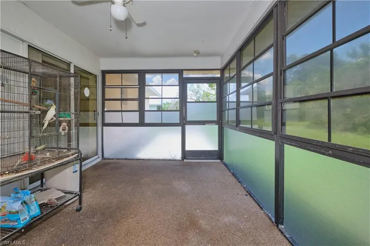 Unfurnished sunroom with ceiling fan
