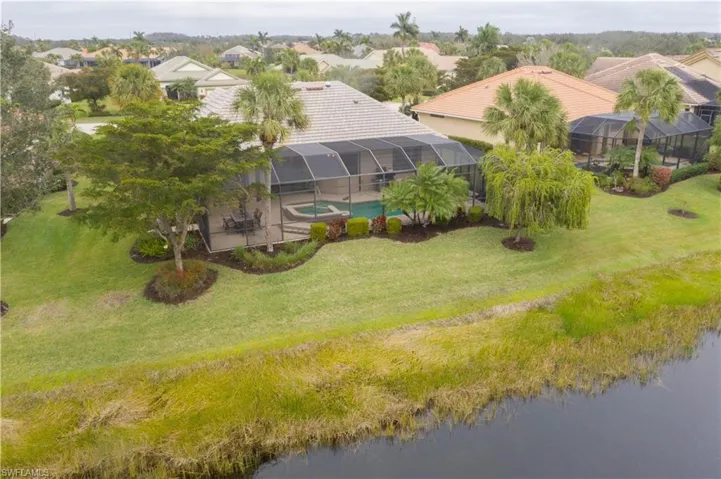 Birds eye view of property with a water view