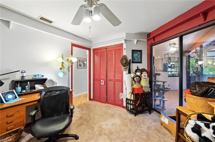 Home office featuring ceiling fan and carpet floors