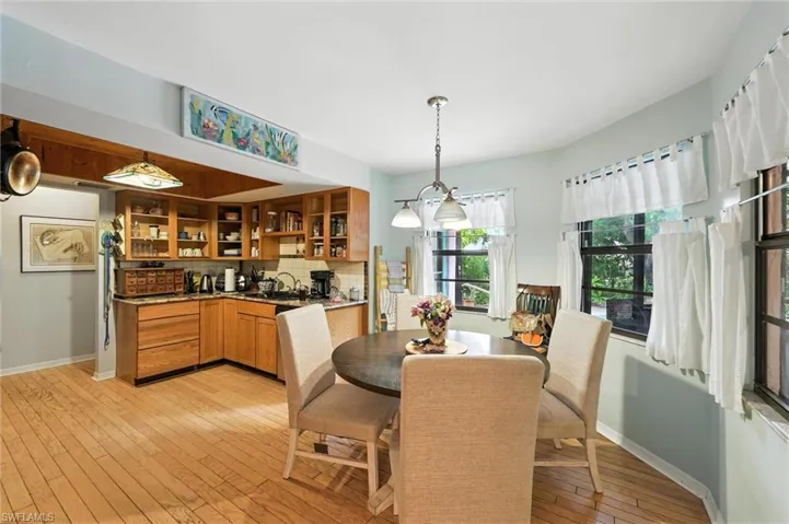 Dining space with light wood-style floors and baseboards