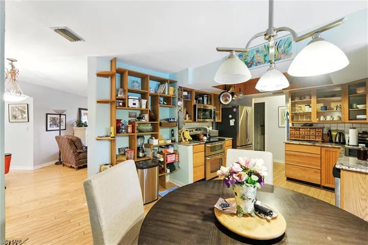 Dining space with light wood-type flooring and baseboards
