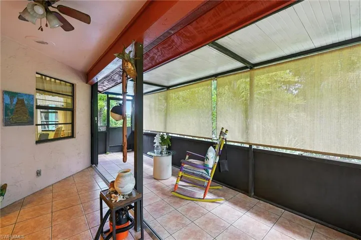 Sunroom / solarium featuring ceiling fan and lofted ceiling