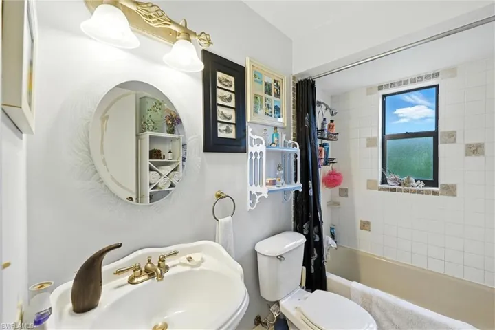 Full bath featuring a sink and shower / tub combo with curtain