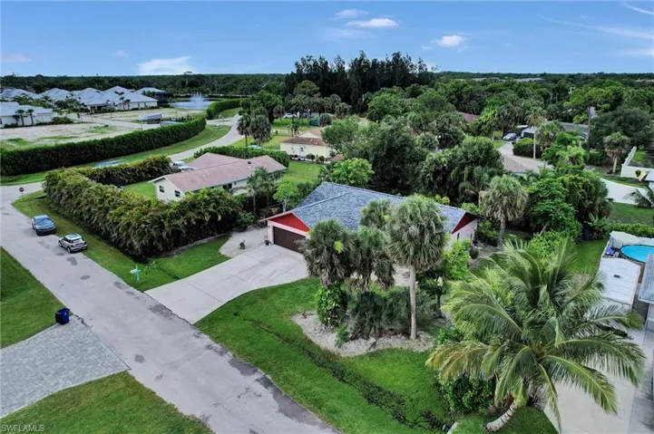 Aerial view of residential area featuring a nearby body of water