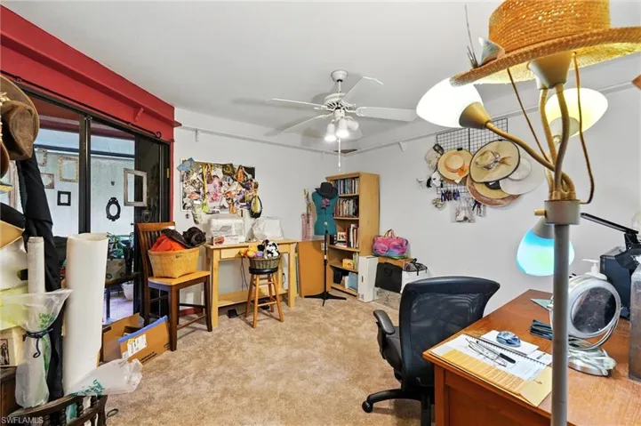 Office area with carpet flooring and ceiling fan