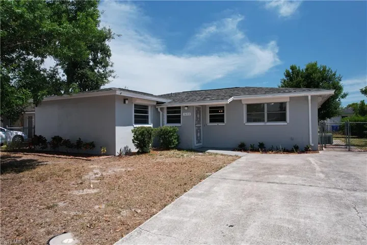 Single story home featuring central air condition unit, stucco siding, a gate, and fence
