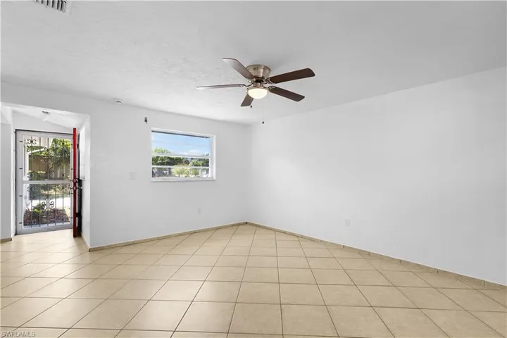 Unfurnished room featuring visible vents and ceiling fan