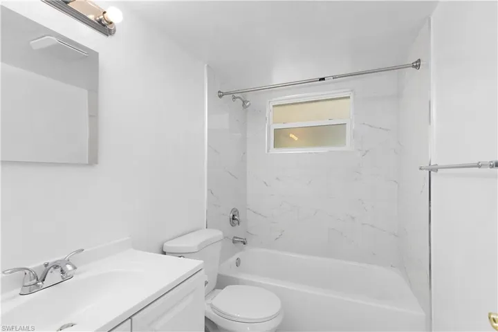 Full bathroom with toilet,  shower combination, and vanity