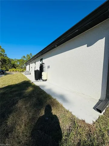 View of side of property with a lawn