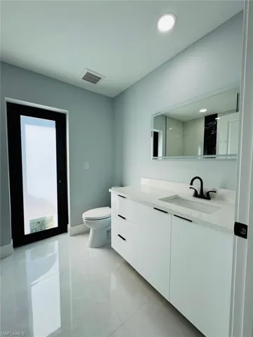 Bathroom featuring vanity and toilet