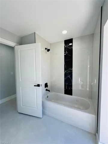 Bathroom with shower / washtub combination