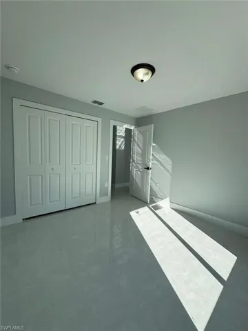Unfurnished bedroom with a closet