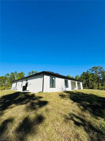 View of side of property with a yard