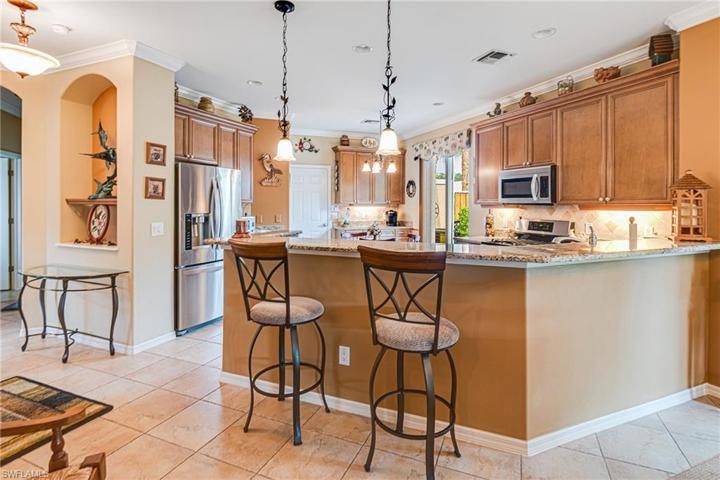 BARSTOOLS & ENTRY GLASS TABLE REMAIN WITH THE HOME! UPDATED BACKSPLASH ENHANCES THE KITCHEN!