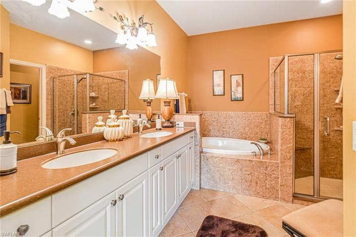 WALK-IN SHOWER, BATHTUB, UPDATED CORIAN COUNTERTOP & MODERN LIGHTING IS SIMPLY BEAUTIFUL!