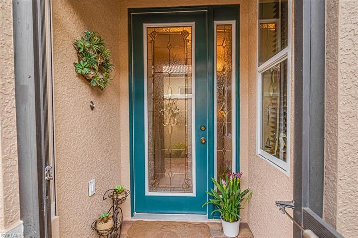 SCREENED-IN & COVERED ENTRYWAY IS EQUIPPED WITH ELECTRIC "STORM SMART" PANEL TO PROTECT YOUR BEAUTIFUL NEW PRIVACY GLASS DOOR!