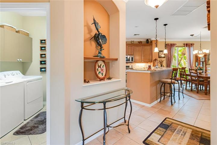 ENTER THRU THE LAUNDRY ROOM TO THE GARAGE WHERE THERE IS A GAS TANKLESS HOT WATER HEATER THAT IS LESS THAN 2 YEARS OLD!
