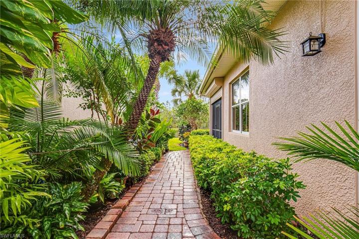 AMAZING PAVERED WALKWAY TO THE BACK OF THE HOME FROM THE SIDE PATIO! SIMPLY BEAUTIFUL! LOOKS LIKE PARADISE!