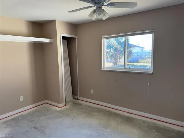 Unfurnished bedroom featuring ceiling fan and a closet